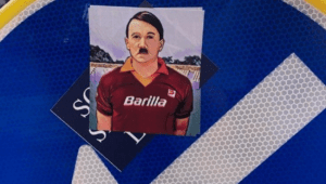 Adesivi di Hitler con la maglietta della Roma: le immaginette di dubbio gusto sono comparse ieri in diversi quartieri della Capitale